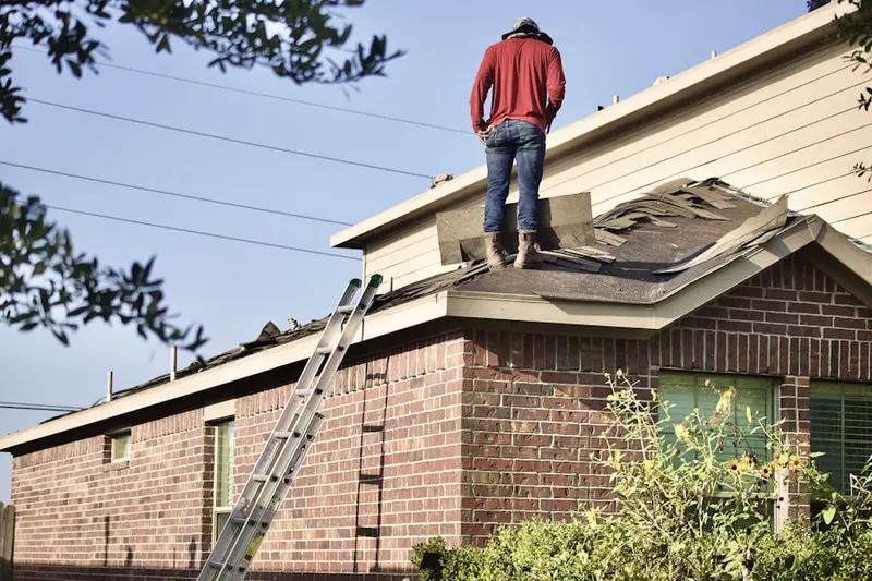 Professional roofer working on a residential roof in Waquoit Village